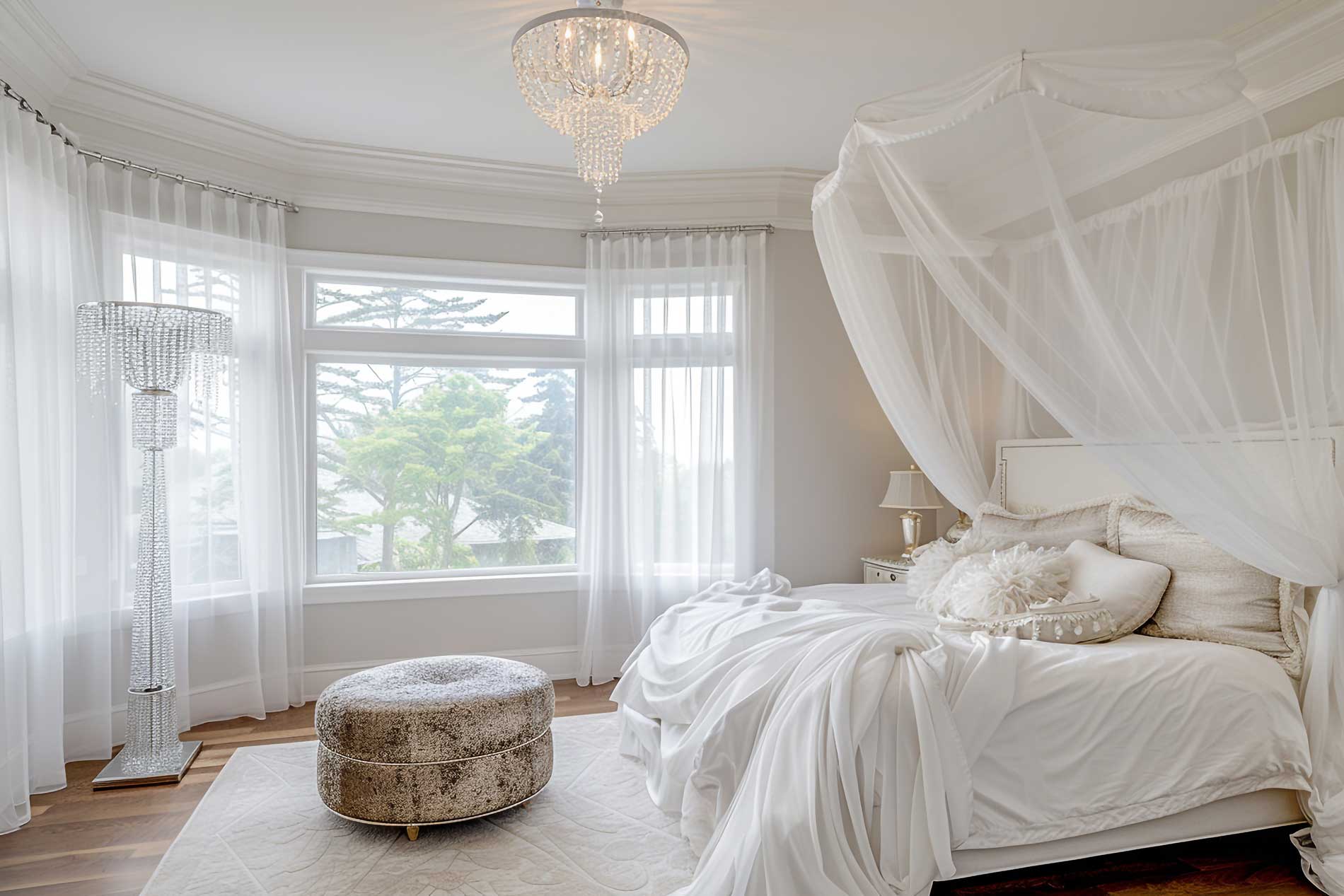 inside of a bedroom with floor to ceiling windows