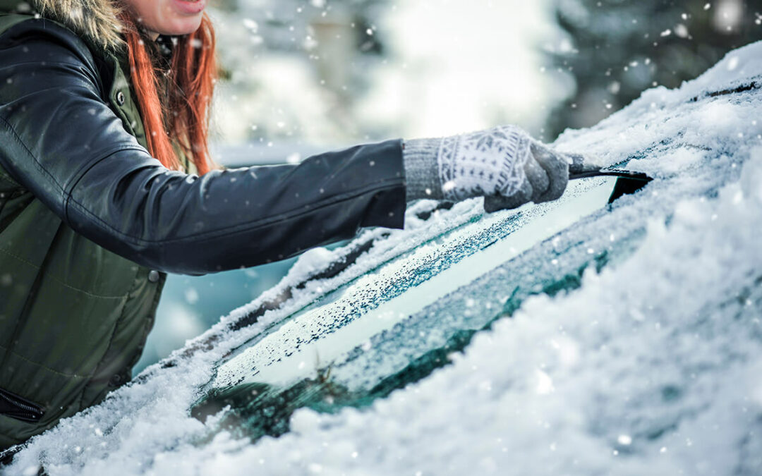 Removing snow from car windshield